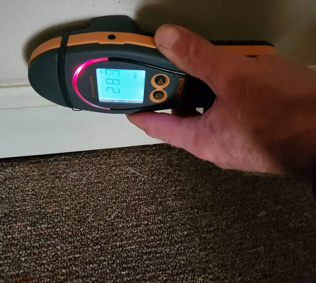 Moisture detection at baseboard during Storm Damage Restoration in Desert Palms